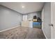 Unfurnished bedroom with neutral grey walls, carpeted floor, and a window providing natural light at 8264 Milam Loop, Fairburn, GA 30213