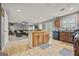 Open kitchen with a large island, wood cabinets, and views into the living room at 8264 Milam Loop, Fairburn, GA 30213