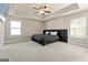 Spacious main bedroom with a large bed and plush carpet at 11976 Lovejoy Crossing Pl, Hampton, GA 30228