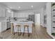 Modern kitchen featuring white cabinets, a large island, and stainless steel appliances at 155 Hedgewick Way, Tyrone, GA 30290