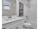 Bright bathroom with a white vanity, framed art, and a shower-tub combination at 720 Lanarck Way, Peachtree City, GA 30269
