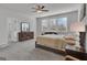 Spacious primary bedroom with a ceiling fan, a walk-in closet, and large windows for ample natural light at 720 Lanarck Way, Peachtree City, GA 30269