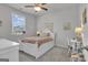 Charming bedroom with a white bed frame, a window with natural light, and cozy decor at 720 Lanarck Way, Peachtree City, GA 30269
