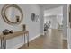 Welcoming entryway with wood flooring, a console table with decor, and views into the open-concept dining spaces at 720 Lanarck Way, Peachtree City, GA 30269