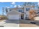 Charming two-story home with a well-maintained lawn and a two-car garage and a lovely dormant tree at 720 Lanarck Way, Peachtree City, GA 30269