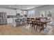 Open kitchen and dining area featuring white cabinets, stainless appliances and a large island at 720 Lanarck Way, Peachtree City, GA 30269