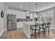 Modern kitchen with stainless steel appliances, white cabinets, quartz counters and a central island with bar stool seating at 720 Lanarck Way, Peachtree City, GA 30269