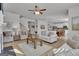 Open-concept living room with modern decor, wood floors, and ample natural light adjacent to the kitchen at 720 Lanarck Way, Peachtree City, GA 30269