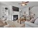Bright living room showcasing a fireplace, built-in shelves, comfortable seating and neutral decor at 720 Lanarck Way, Peachtree City, GA 30269