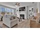 Open-concept living room showcasing a fireplace, built-in shelves, and comfortable seating with lots of windows at 720 Lanarck Way, Peachtree City, GA 30269