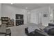 Open-concept bonus room with a large TV, dark furniture, and neutral-colored walls at 720 Lanarck Way, Peachtree City, GA 30269