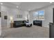 This living room offers a black leather sofa, a piano and lots of natural light at 720 Lanarck Way, Peachtree City, GA 30269