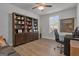 Bright office featuring a large dark wood bookshelf, desk with rolling chair, and natural light at 720 Lanarck Way, Peachtree City, GA 30269