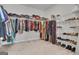 Spacious walk-in closet with ample storage, featuring shelves and hanging rods for clothes and shoes at 720 Lanarck Way, Peachtree City, GA 30269