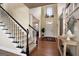 Two-story foyer with hardwood floors, staircase, and decorative console table at 1152 Chadwick Lakes Dr, Lawrenceville, GA 30043