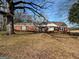 Brick ranch house with mature trees and a spacious yard at 526 Mcdonald Rd., Covington, GA 30016