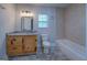 Bathroom with granite vanity, tub, and tiled shower at 1198 E Atlanta Rd, Stockbridge, GA 30281