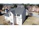 Rear view of a two-story house with a deck, white trim, and a well-maintained yard at 3226 Masters Pass Ln, Snellville, GA 30039