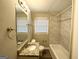 Clean bathroom with a granite vanity and tiled bathtub at 50 Macon Se Pl, Atlanta, GA 30354