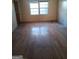 Hardwood floor living room with two windows at 6238 Lance Ln, Riverdale, GA 30274