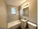 Updated bathroom with marble-look tile, granite vanity, and a bathtub at 425 Cologne Se Dr, Atlanta, GA 30354