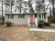Charming gray brick ranch home with updated landscaping and a vibrant coral door at 425 Cologne Se Dr, Atlanta, GA 30354