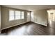 Bright living room featuring wood-look floors, neutral walls, and an interior door at 425 Cologne Se Dr, Atlanta, GA 30354