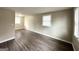 Spacious living room with neutral walls, wood-look floors, and large windows at 425 Cologne Se Dr, Atlanta, GA 30354