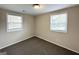 Spacious bedroom with neutral walls, carpet, and two windows at 348 Cologne Se Dr, Atlanta, GA 30354