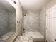 Updated bathroom with marble tile shower/tub combo and granite vanity at 1351 Renee Dr, Decatur, GA 30035