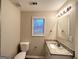 Bathroom with granite countertop, large mirror and toilet at 1351 Renee Dr, Decatur, GA 30035