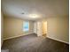 Spacious carpeted bedroom with a window and an adjacent door to a hallway at 1351 Renee Dr, Decatur, GA 30035