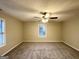 Spacious carpeted bedroom with a window featuring mini blinds and ceiling fan at 1351 Renee Dr, Decatur, GA 30035