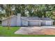 Newly renovated house with gray siding, a two-car garage, and a spacious front yard at 1351 Renee Dr, Decatur, GA 30035