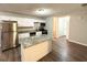 Modern kitchen with white cabinets, granite countertops, and a large island at 1351 Renee Dr, Decatur, GA 30035