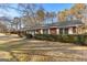 Brick ranch house with a well-manicured lawn and landscaping at 305 Kelly Dr, Fayetteville, GA 30214