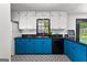 Updated kitchen boasts bright blue lower cabinets, white upper cabinets, and patterned tile flooring at 305 Kelly Dr, Fayetteville, GA 30214