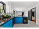 Updated kitchen with blue cabinets, black appliances, granite countertops and patterned tile flooring at 305 Kelly Dr, Fayetteville, GA 30214