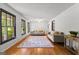 Bright living room featuring hardwood floors, neutral sofas, and a decorative area rug at 305 Kelly Dr, Fayetteville, GA 30214
