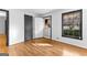 Bright room with hardwood floors, fresh paint, and natural light from the large window at 305 Kelly Dr, Fayetteville, GA 30214