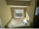 Relaxing bathroom with garden tub and window at 270 Mountain Way, Covington, GA 30016