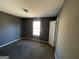 Simple bedroom with gray walls, carpet, and a window at 270 Mountain Way, Covington, GA 30016