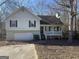 Light green house with a white porch and attached garage at 270 Mountain Way, Covington, GA 30016