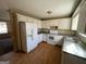 Galley kitchen with white cabinets and laminate flooring at 270 Mountain Way, Covington, GA 30016