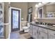 Bathroom with granite vanity, decorative mirror, and private exterior access at 506 W Mcintosh Rd, Brooks, GA 30205