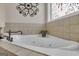 Corner jacuzzi tub with tile surround and decorative window at 506 W Mcintosh Rd, Brooks, GA 30205