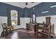 Bedroom with wood floors, antique furniture, and large windows at 506 W Mcintosh Rd, Brooks, GA 30205