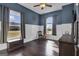 Bedroom with wood floors, large windows, and a ceiling fan at 506 W Mcintosh Rd, Brooks, GA 30205