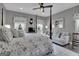 Bright bedroom with a post bed, ceiling fan, and view of the backyard at 506 W Mcintosh Rd, Brooks, GA 30205