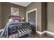 Bedroom with metal bed frame, wall art, and hardwood flooring at 506 W Mcintosh Rd, Brooks, GA 30205